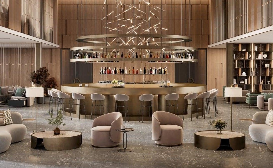 Shared club space at Common Ground with a circular bar, lounge chairs and feature lighting